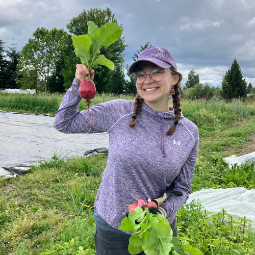 Volunteer holding a bunch of radishes 