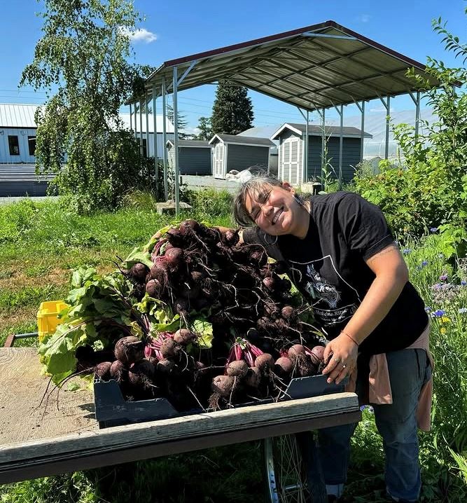 Farmer Giselle hugging a cart full of beats