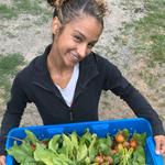 Joslyn with a bin of veggies 