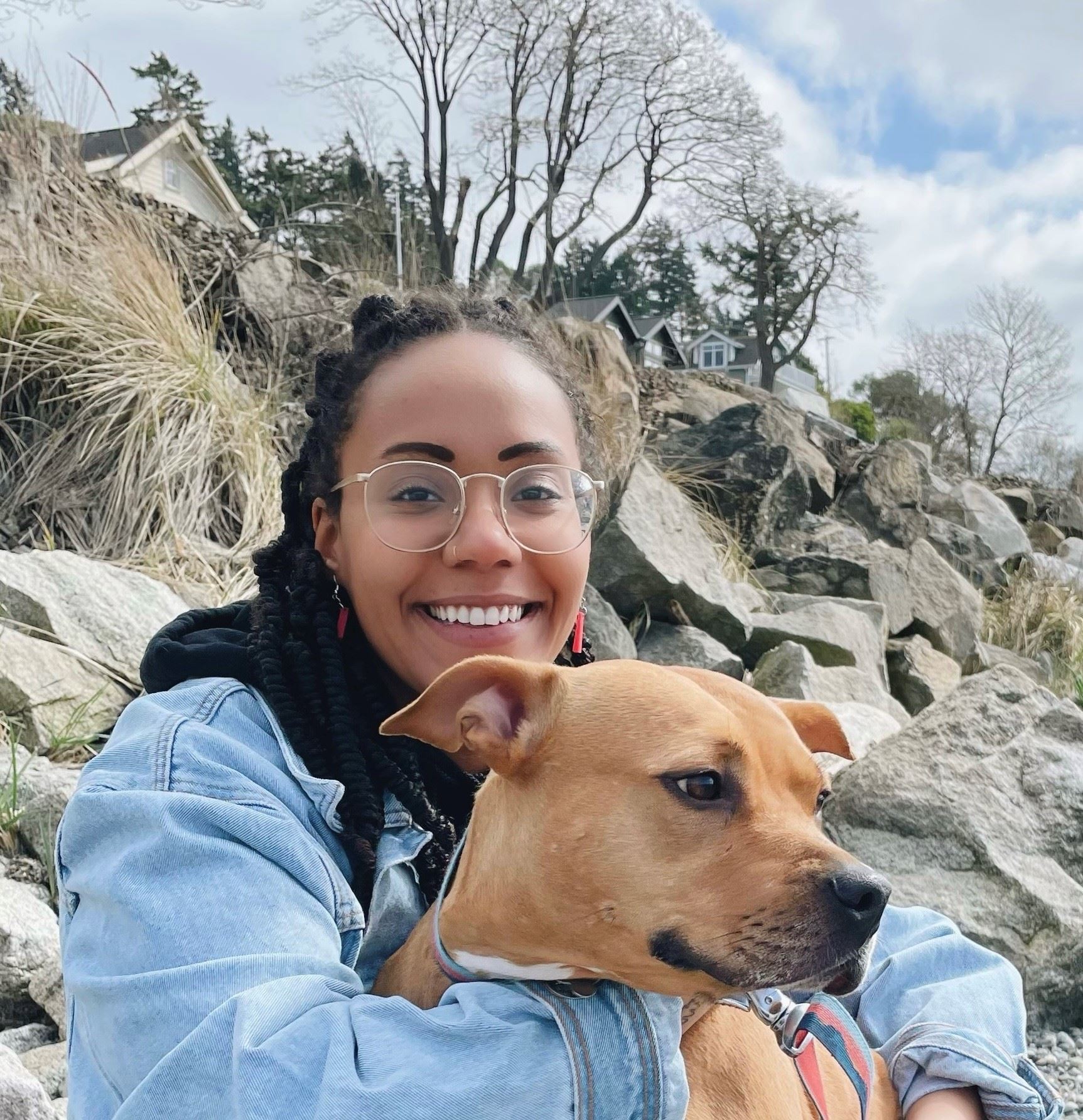 Thabisa Mazur facing forward holding a dog